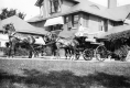 Horse-drawn carriage in front of brick building