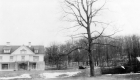 Wooden-frame house and leafless deciduous trees