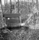 Creek alongside small wooden structure