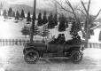 Henry Root in a car in front his home