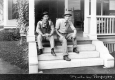 Two Men in Front of Home