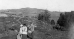 Three Individuals Standing in Front of Mountain