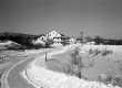 Snowy road and house