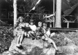 Boys and Girls sitting on a large rock