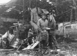Family in Front of Wreckage