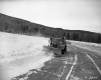 Snow Plow with Car in Background
