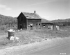 Trash Can and Abandoned House on Route 12