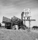 Burlington Interstate 89 Three Men Two Securing Sign