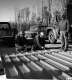 Three Men Two Trucks and a Car