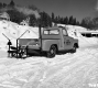 Truck with Two Houses and Garage Exhaust Coming Out