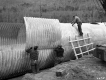 Three Men Work on Multiplate Pipe Construction on Relocated US RT 2