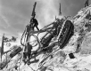 Two Men with Machinery on Steep Outcrop