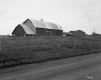 Barn and Buildings Next to Roadway