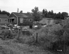 Shingled Dwelling with Lawn Covered in Objects
