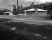 Two Houses Next to Paved Road