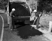 Two Men Work on Road Construction