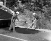 Two Men Work to Patch Road