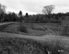 Field Next to Road and Train Tracks