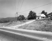 House by Paved Road and Mountains