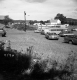 Cars and Houses in Field