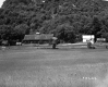 Barns and House Along Road and Meadow