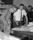 Two Men Look Over Documents