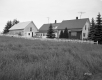 House and Barn lined by Wooden Fence