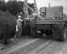 Three Men and Construction Vehicle at Guardrail Installation