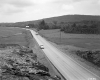 Two Vehicles on Road with Outcrop 
