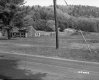 Building and Field Next to Paved Road