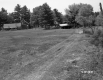 Field with Fence and Buildings