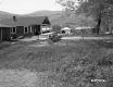 Two Houses with Garages and Automobiles