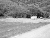 Shack and Truck Next to Mound of Gravel