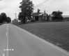 Two Dwellings Next to Paved Road