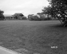 Dilapidated Building and Field with Plants