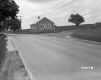 Stone Building Next to Road and Field