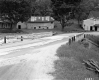 Three Buildings Stand Next to Road and Bridge