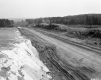 Dirt Road Under Construction with Trucks and Machinery
