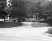Two Buildings and Driveway Next to Paved Road