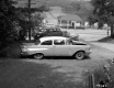 Two Parked Automobiles and a Boat