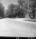 Downtown Village Street with Cars and People 