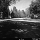 Rural Road with Angel Statue and Dwellings