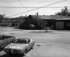 Cars by Wooden Building