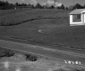 Dwellings and  Grassy Lawns near Rural Road