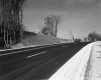 Car Traveling Downhill on Highway