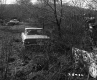 Unpaved Lot with Automobiles and Debris
