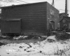 Wood siding Building with Chimney in the Background