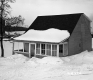 Dwelling with Parking Lot and Brick Commercial Building
