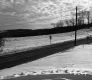 Hilly Road with Snow Fields