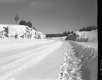 Snowy Highway with Rocky Outcrops